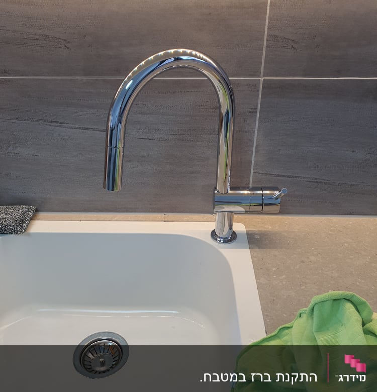 ברז נירוסטה מעל כיור מטבח לבן